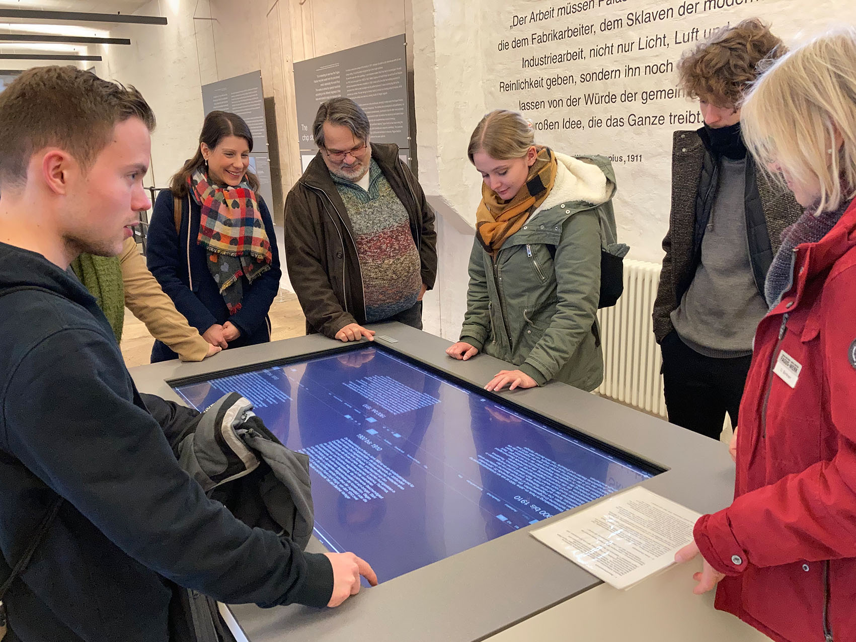 Führung durch das Fagus-Werk in Alfeld. Dozierende und Studierende bestaunen Infografik.