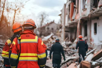 Mitarbeiter des Rettungsdienstes helfen, nachdem ein Haus zusammengestürzt ist.